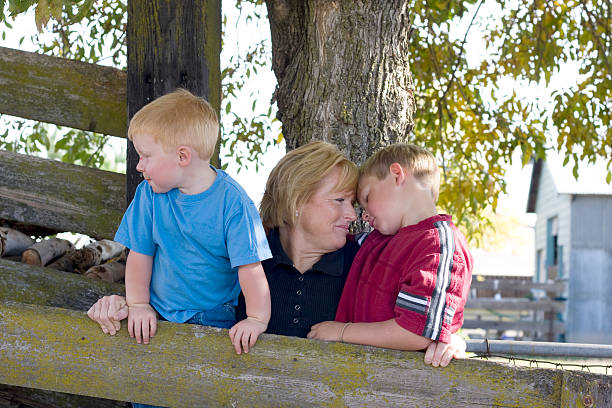Mom and boys enjoy a quiet moment stock photo