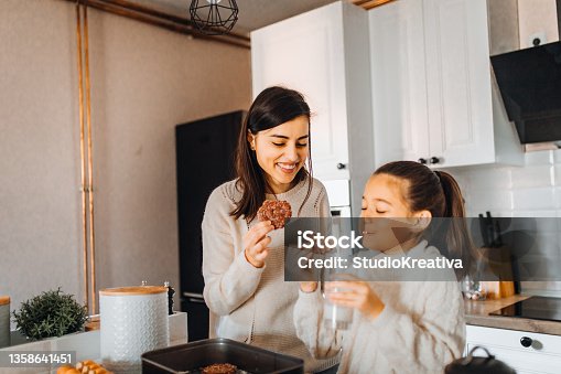 istock Mom and daughter baking cakes in her kitchen 1358641451