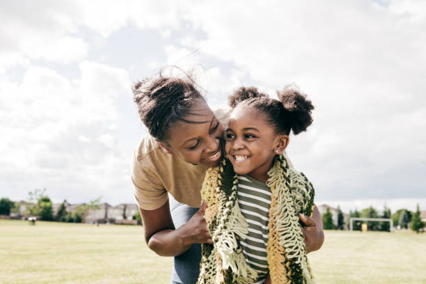 Mom and little daughter outdoor Supportive mom and little daughter african american ethnicity photos stock pictures, royalty-free photos & images