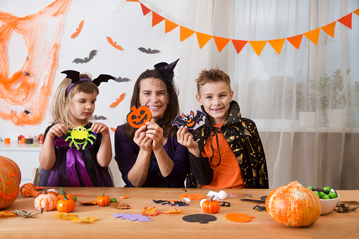 Mom With Two Children In Masquerade Costumes Make Decor And Crafts For ...