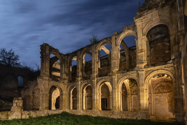 Monastery Of Santa Maria de Rioseco Ruins of mediaval monastery at night abbey monastery stock pictures, royalty-free photos & images