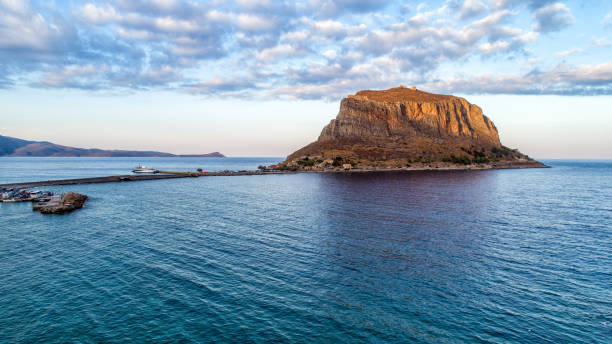 Monemvasia on Peloponnese, Greece Monemvasia, small rocky peninsula next to Peloponnese with small settlement, located in Greece. View from the town Gefira before sunset, with soft sunlight laconia greece stock pictures, royalty-free photos & images