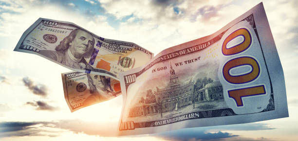 Money 100$ dollar bills flying on sky Money 100$ dollar bills flying on sky. USD currency economics federal reserve stock pictures, royalty-free photos & images