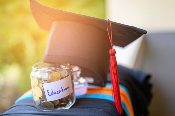 Money for education placed in a glass jar stock photo