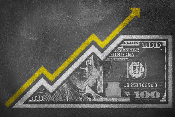 Money Growth Graph on a chalk board A money bill drawn on a chalk board looking like a growth graph with an upwards pointing arrow symbolizing economic relationships. inflation economics stock pictures, royalty-free photos & images