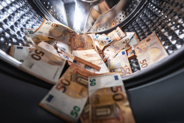 money laundering concept - euro banknotes in washing machine money laundering concept - euro banknotes in washing machine money laundering stock pictures, royalty-free photos & images