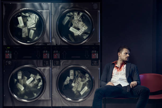 Money laundering Portrait of gangster washing US dollars. Money laundering concept. money laundering stock pictures, royalty-free photos & images