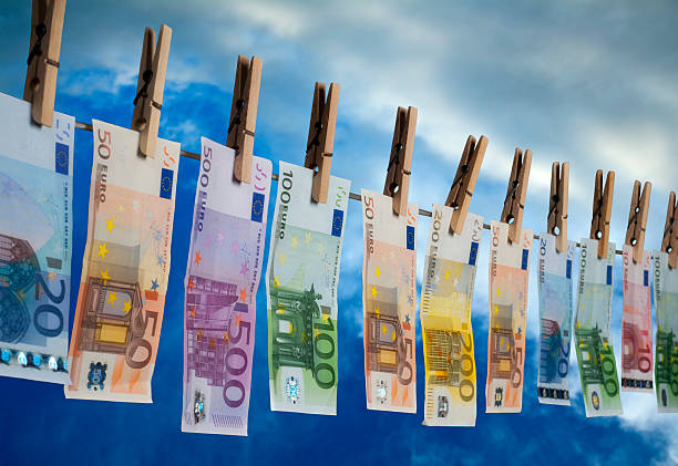 Money Laundering Euro notes with different value hanging on a line for drying money laundering stock pictures, royalty-free photos & images