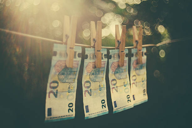Money Laundering Euro notes hanging on a line for drying money laundering stock pictures, royalty-free photos & images