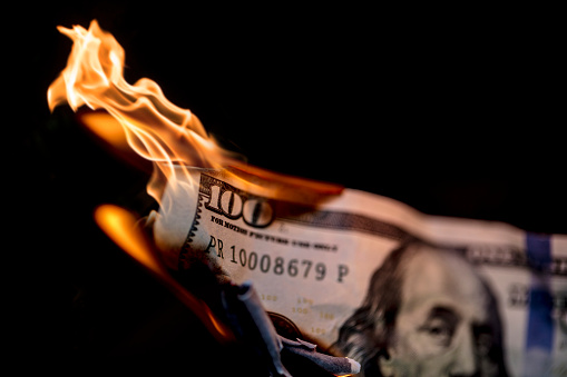 A stock photo of 100 dollars on fire. Please note the money is not real and is marked 