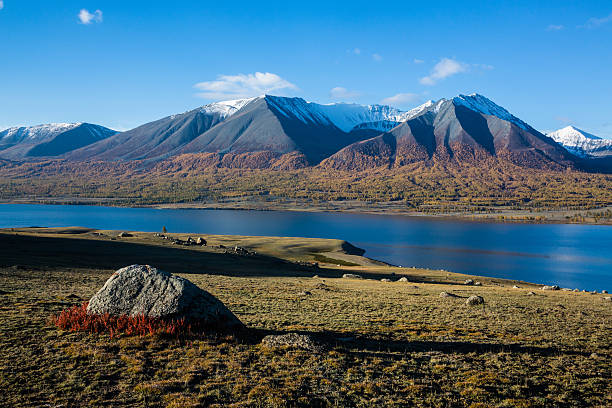 Mongolian Altai mountain range with blue lake Khoton Nuur Snow covered Mongolian Altai mountain range on the border between Mongolia, China and Russia. altai mountains stock pictures, royalty-free photos & images