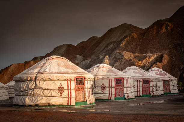 Mongolian yurts ar Zhangye Danxia geopark rainbow mountains in China. Mongolian tents at the Rainbow mountains of Zhangye Danxia Geopark in the Gansu province, China. danxia landform stock pictures, royalty-free photos & images