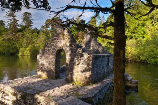 Monk's Fishing House, Cong, County Mayo, Ireland A 13th Century ruin on the Cong River.  The elegant arched entrance to the Monk's Fishing House, part of Cong Abbey, County Mayo, Ireland michael stephen wills cong stock pictures, royalty-free photos & images