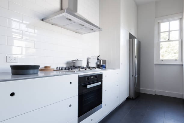 Monochrome Clean White Kitchen Benchtop And Cupboards Stock Photo