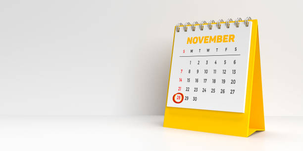 Monthly 3D calendar for 28th November reminder for Veterans day celebration. Special days concept: Important holidays and events marked in red on a white and yellow monthly desktop calendar for 2021. A modern reminder to prepare for that extra day. White background with large blank space for additional text message. memorial day background stock pictures, royalty-free photos & images