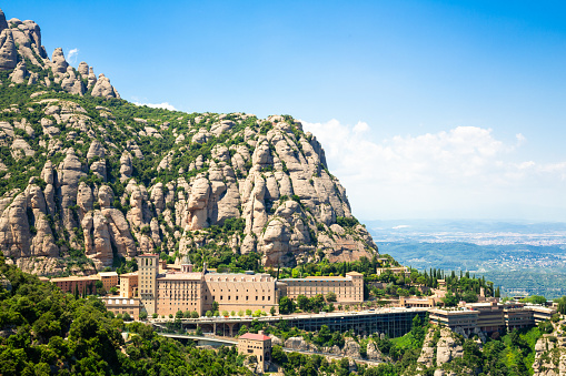 Montserrat Monastery is located on the mountain of Montserrat, Catalonia, Barcelona, Spain Sunny day, blue sky