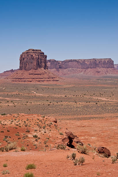 Monument Valley from Artist Point Monument Valley, on the Arizona - Utah border, gives us some of the most iconic and enduring images of the American Southwest. The harsh empty desert is punctuated by many colorful sandstone rock formations. It can be a photographer's dream to capture the ever-changing play of light on the buttes and mesas. Even to the first-time visitor, Monument Valley will probably seem very familiar. This rugged landscape has achieved fame in the movies, advertising and brochures. It has been filmed and photographed countless times over the years. If a movie producer was looking for a landscape that epitomizes the Old West, a better location could not be found. This picture of Monument Valley was photographed from Artist Point off the Monument Valley Road north of Kayenta, Arizona, USA. jeff goulden monument valley stock pictures, royalty-free photos & images