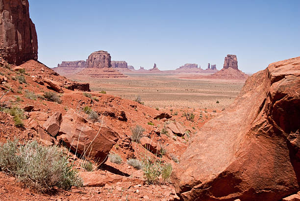 Monument Valley from North Window Overlook The American Southwest has some amazing landscapes, especially the colorful rock formations. The background of blue sky adds color, depth and contrast to the scene. This view of rock formations is in Monument Valley Tribal Park in Arizona, USA. jeff goulden monument valley stock pictures, royalty-free photos & images