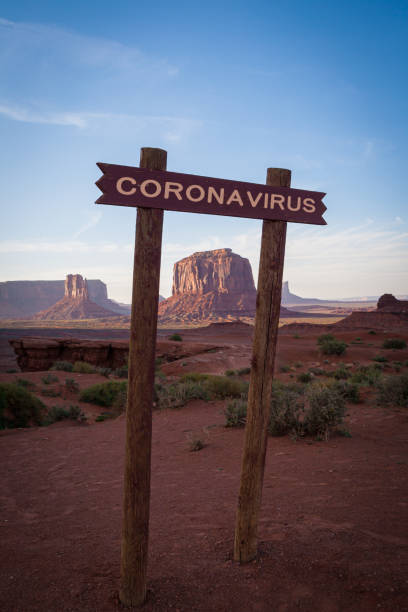 Monument valley wiew with a coronavirus sign on the foreground Monument valley wiew with a coronavirus sign on the foreground . USA shutdown and coronavirus or covid-19 crisis. navajo nation covid stock pictures, royalty-free photos & images