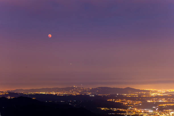 Moon elcipse in barcelona - 27th July 2018 Moon Eclipse views from Montserrat, looking towards Barcelona. blood moon stock pictures, royalty-free photos & images
