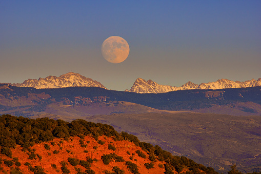 Moonrise Over Red Rocks and Gore Range - Scenic views of full moon rising over ridge time lapse.