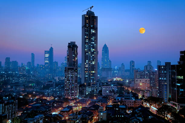 Moonrise over south central Mumbai - the financial capital of India - showing a glittering metropolis Moonrise over south central Mumbai - the financial capital of India - showing a glittering metropolis with a reputation of city that never sleeps with dwellings of lower middle class in foreground and newer towers where elite stay in the far background. india stock pictures, royalty-free photos & images