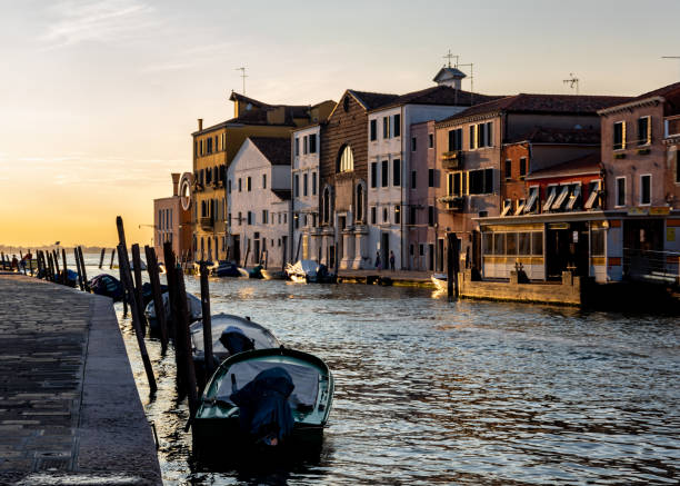 Moored boats in a Venice canal at sunset stock photo