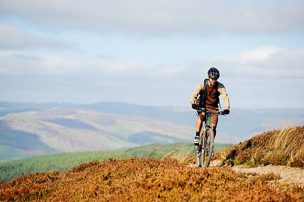 A young man rides on a purpose built trail across a moor in the Scottish Borders