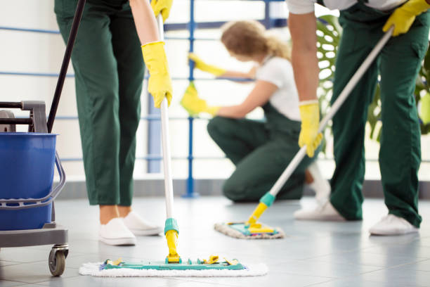 Moping floor and cleaning railing Coworkers moping a floor and a woman dusting a railing in an office cleaning company stock pictures, royalty-free photos & images