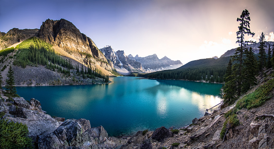 The emerald waters of Moraine Lake at sunset.  A panoramic photo.