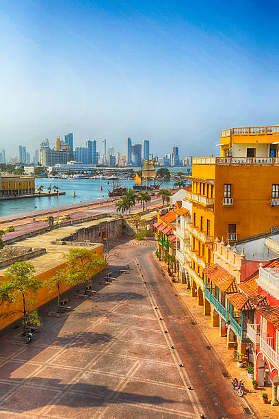 Morning in Cartagena Cartagena, Colombia - February 23, 2014 - View of the Plaza San Pedro Claver with the Towers of Bocagrande in the background. The early morning calm before the shops open for business. colombia stock pictures, royalty-free photos & images