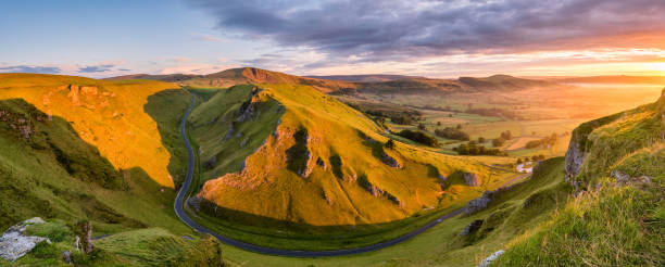 Morning Light At Winnats Pass In The Peak District. Wide panoramic view of Winnats Pass in the Peak District with vibrant morning light. peak district national park stock pictures, royalty-free photos & images