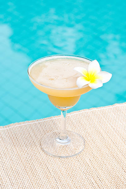 Morning Margarita cocktail near waterpool on the mat stock photo