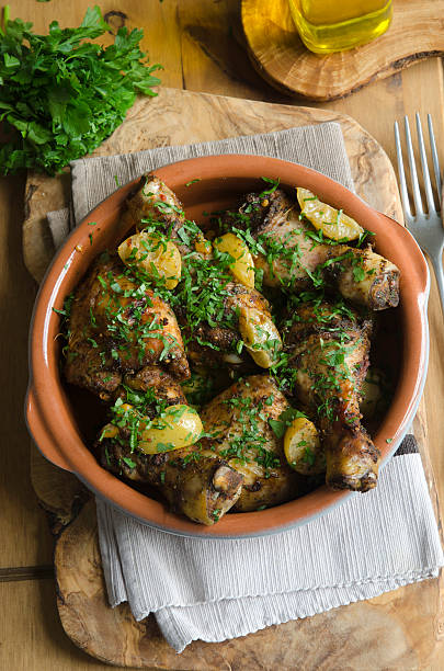 Moroccan chicken stew Chicken drumsticks and thighs with Ras el Hanout, preserved lemon and apricot chicken thigh meat stock pictures, royalty-free photos & images