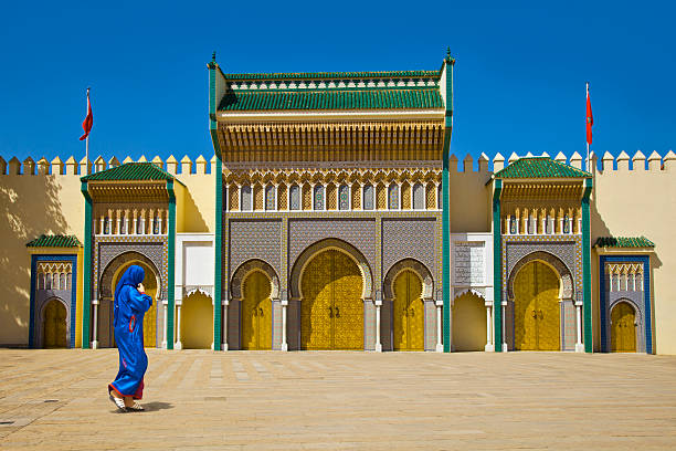 Morocco Women in blue in Fez, door of Royal palace. fez morocco stock pictures, royalty-free photos & images