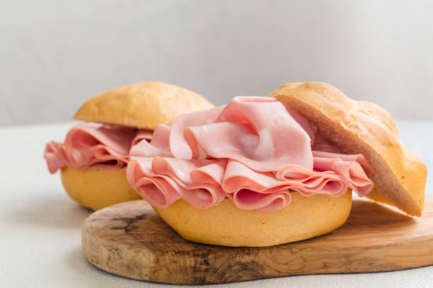 Mortadella sandwich Mortadella sandwich. Mortadella Bologna - a large italian sausage or luncheon  with meat. Tipycal italian bread - La Rosetta. ham stock pictures, royalty-free photos & images