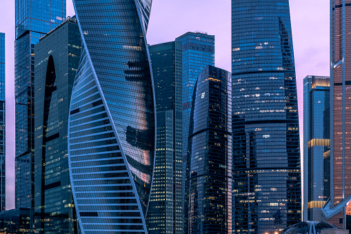 The Moscow International Business Center (Moscow-City) skyscrapers against blue evening sky.