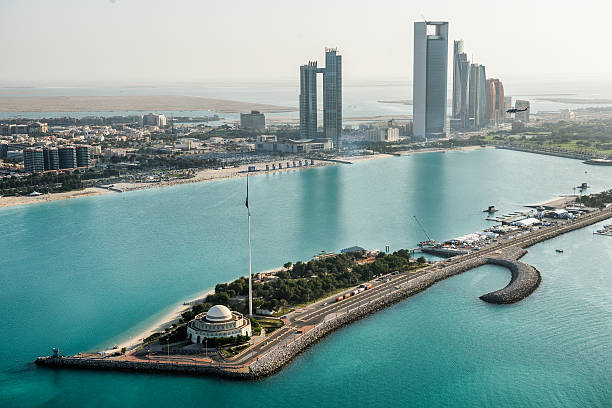 Mosque and coastline in Abu Dhabi Helicopter point of view of Mosque in Abu Dhabi, UAE. Turquoise water, nationla flag and skyscrapers are also visible. abu dhabi stock pictures, royalty-free photos & images