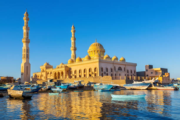 Mosque with fishing boats at sea in egypt stock photo