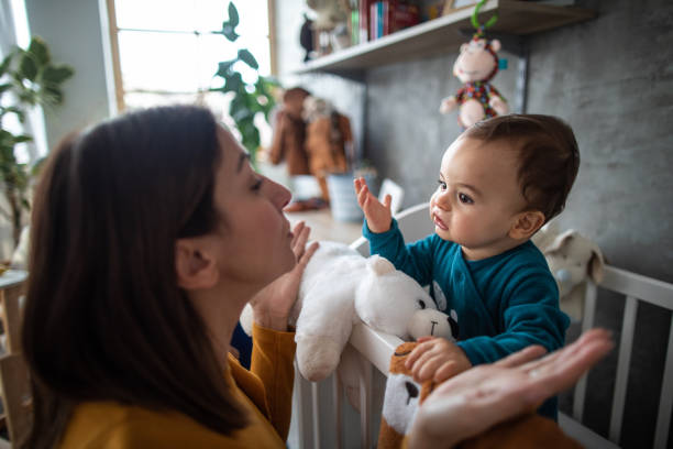 Mother and baby boy trying to understand each other stock photo