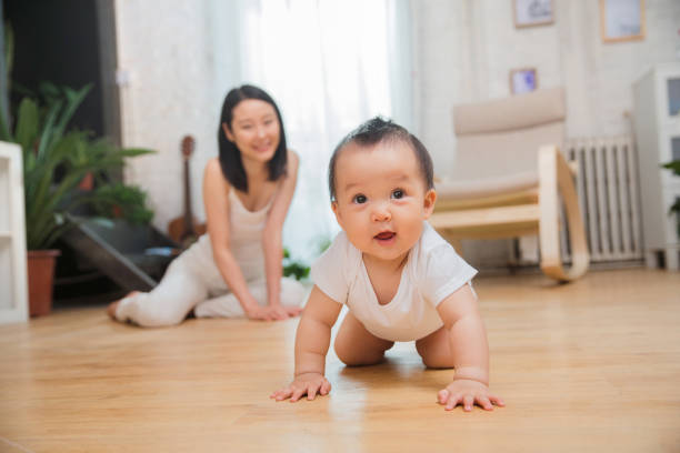 Mother and baby Mother and baby crawling stock pictures, royalty-free photos & images