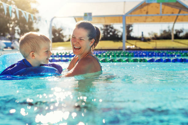 Mother and child in swimming pool stock photo