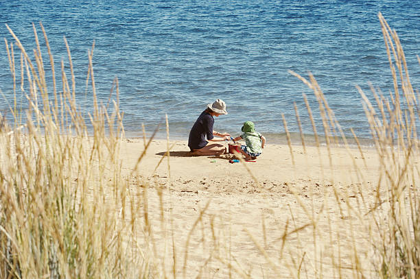 mother and child playing on beach - summer sweden bildbanksfoton och bilder