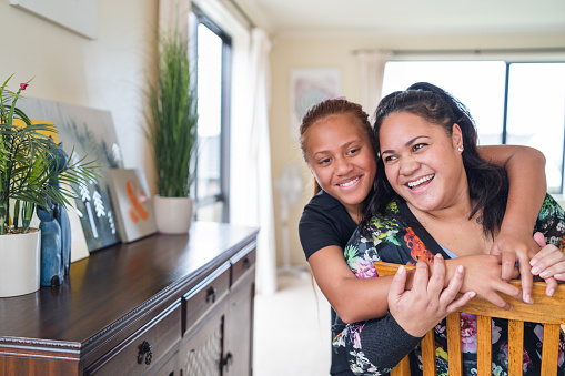 Maori mother spending quality time with kids at home in Auckland, New Zealand.