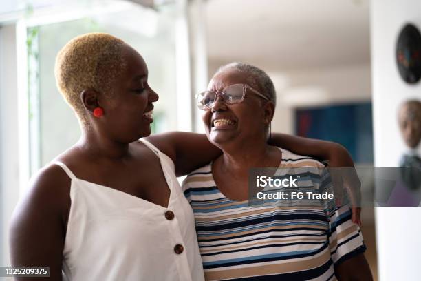 Mother and daughter embracing at home