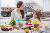 istock A mother and daughter pack sandwiches and fresh food into clear storage bags in a bright modern kitchen. 1365990553
