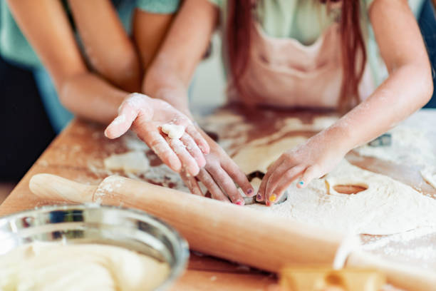 Mother and daughter preparing the dough,make pastries stock photo