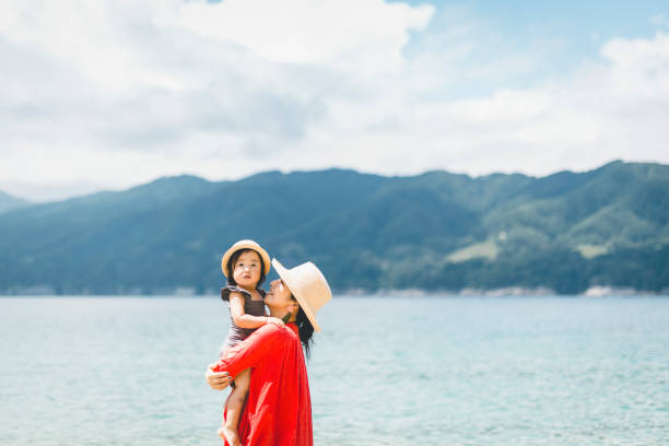 Mother and daughter relaxed in the beach Asian family playing at seaside. pacific ocean photos stock pictures, royalty-free photos & images