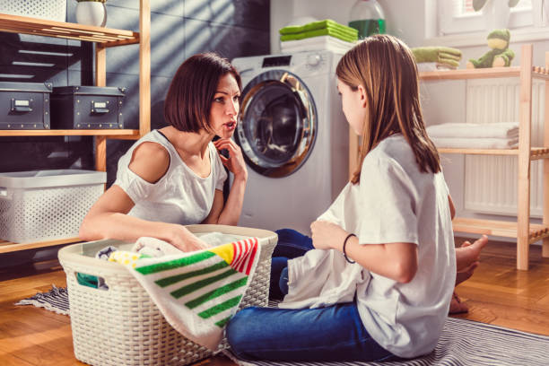 mother-and-daughter-talking-and-sorting-laundry-on-the-floor