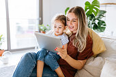 istock Mother and daughter using a digital tablet together 1344564276